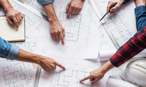 team-architects-collaborating-blueprints (1)